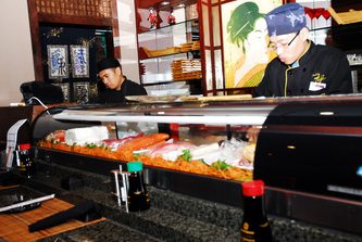 A chef preparing a fresh batch of sushi.